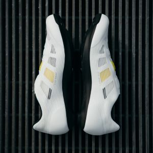 A pair of Macha Pro shoes in white facing sole to sole.